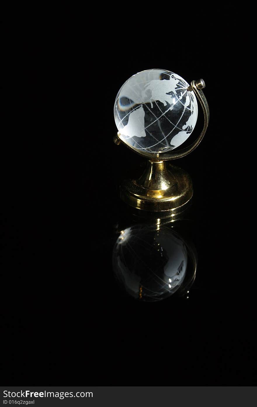 Little glassy globe with reverberation standing on dark background