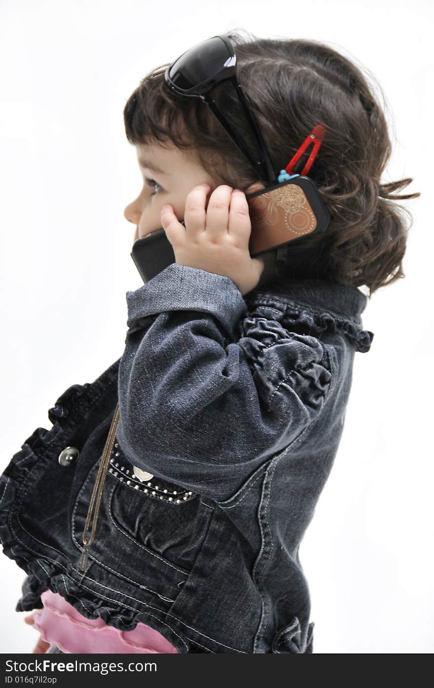 Portrait of little girl which speaks by phone. Portrait of little girl which speaks by phone