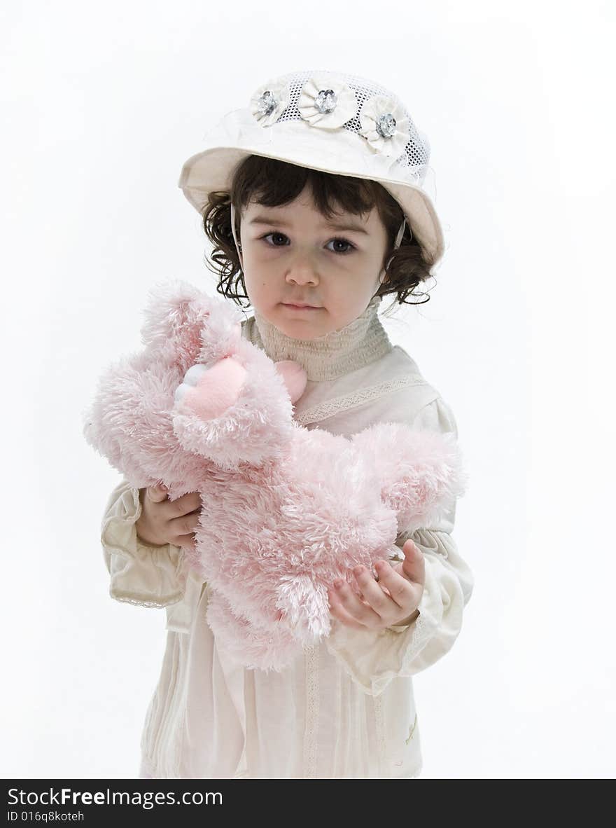 Portrait of a be single little girl and little pink elephant