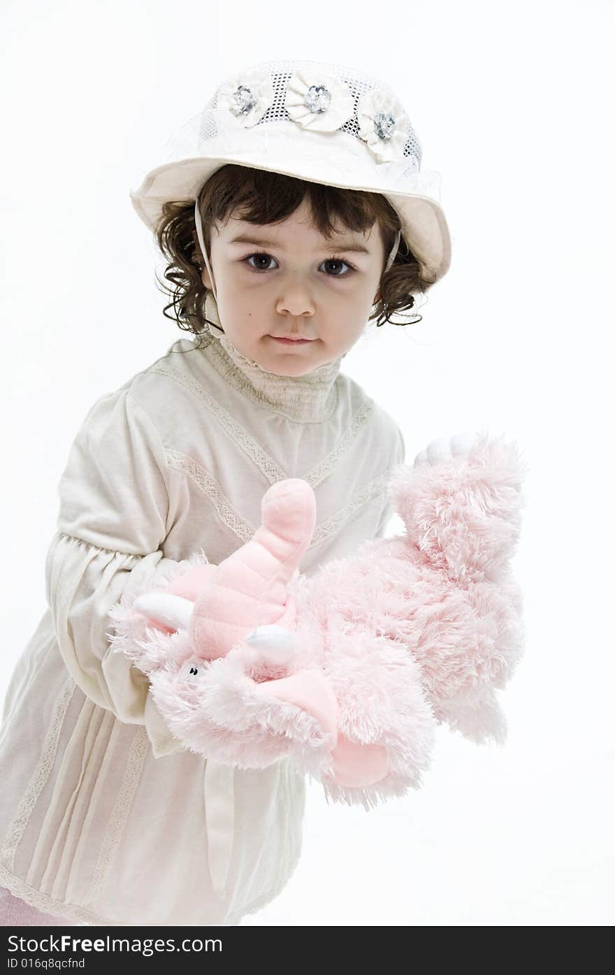 Portrait of a be single little girl and little pink elephant