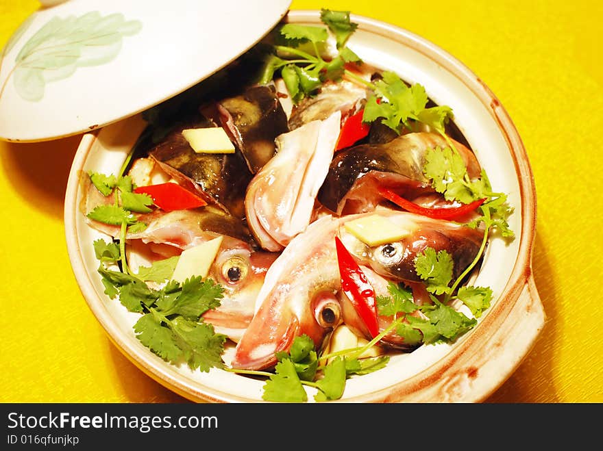 The Chinese dish of braised fresh water fish heads in a pottery casserole. The Chinese dish of braised fresh water fish heads in a pottery casserole.