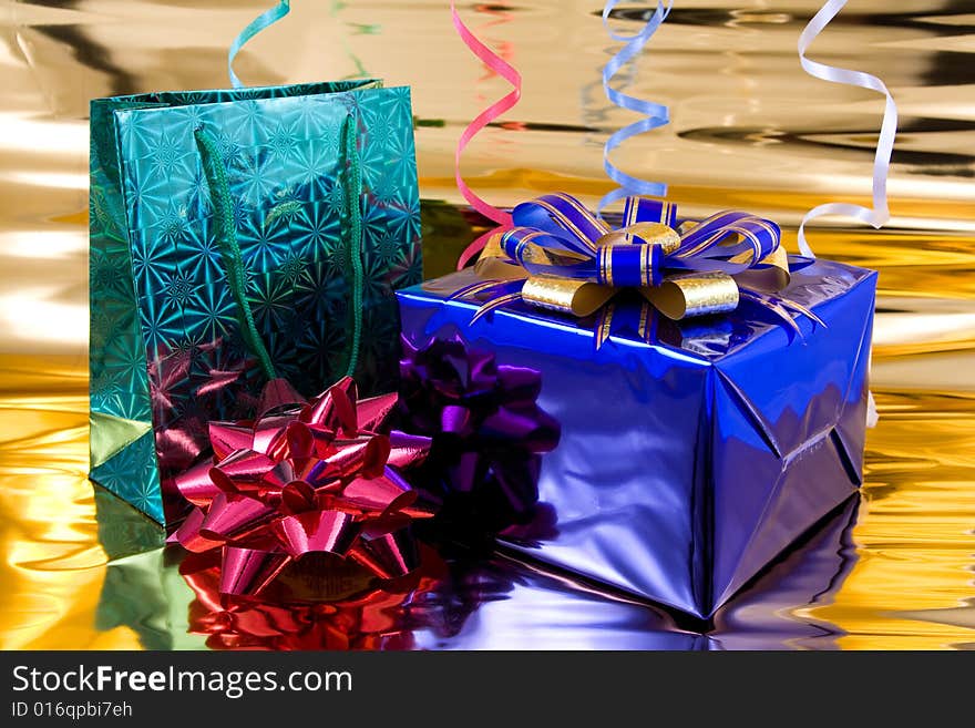 Blue and green gift boxes on a golden background