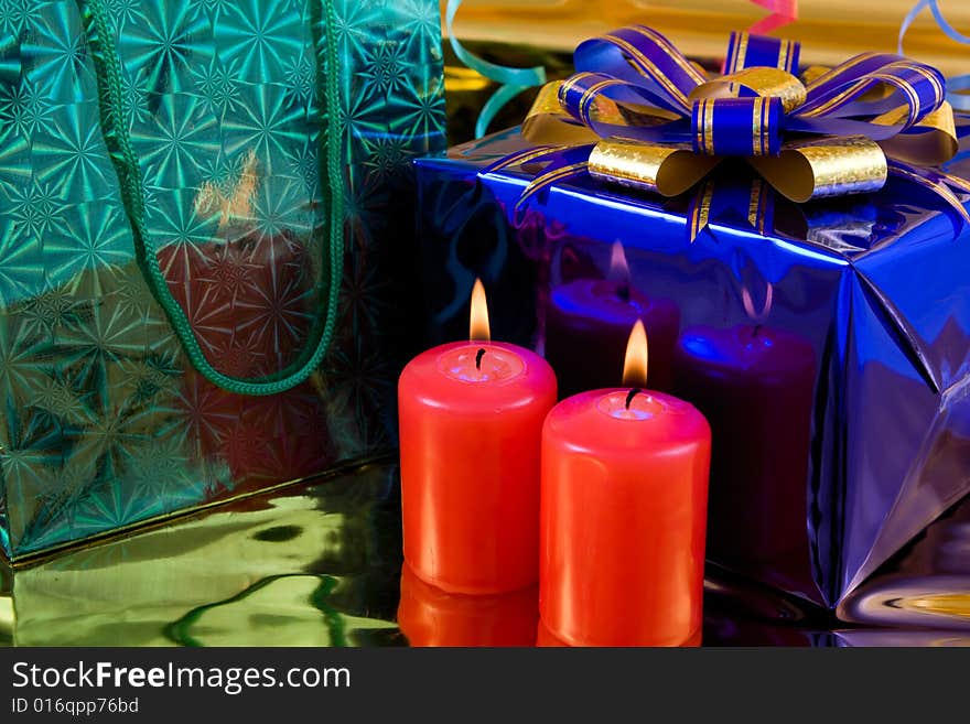 Blue gift box and red burning candles. Blue gift box and red burning candles