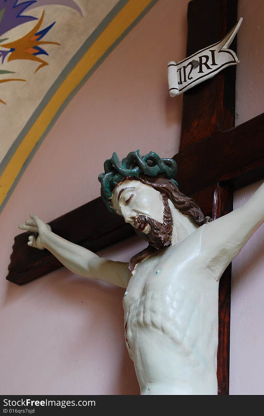 Jesus of Nazaret on cross. Figure in church St. Bartolomeo - village Szyszki, state mazowieckie, Poland. The church of St. Bartolomeo is a historic cathedral constructed in 15th century, reconstructed in 1877-1899 years. It is the church of the Roman Catholic Diocese Płock. Jesus of Nazaret on cross. Figure in church St. Bartolomeo - village Szyszki, state mazowieckie, Poland. The church of St. Bartolomeo is a historic cathedral constructed in 15th century, reconstructed in 1877-1899 years. It is the church of the Roman Catholic Diocese Płock.