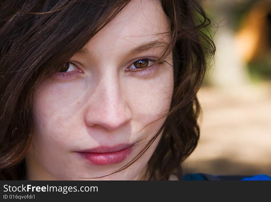 Close woman portrait with her hair on the wind