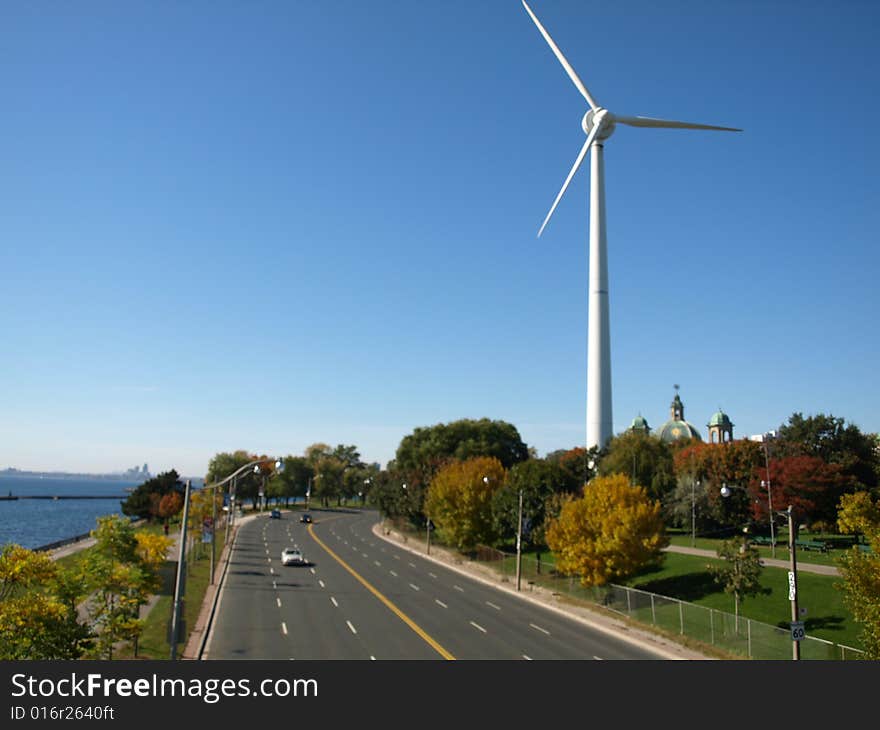 A power generating windmill beside a North American highway. A power generating windmill beside a North American highway.