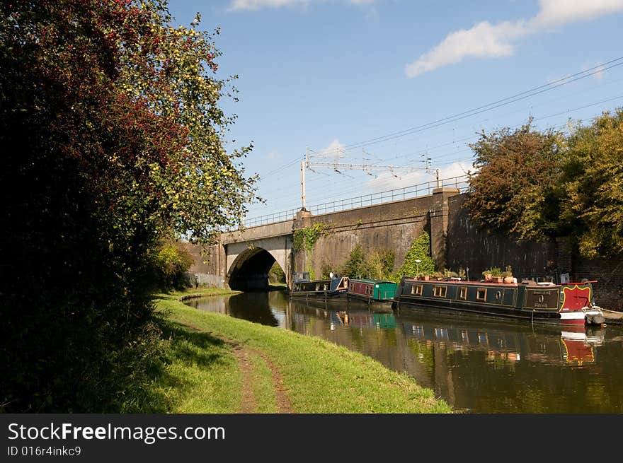 An intercity train crosses a bridge over a canal barge. An intercity train crosses a bridge over a canal barge