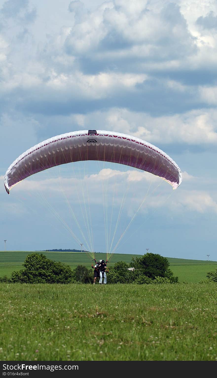 Tandem paragliding in cloudscape area