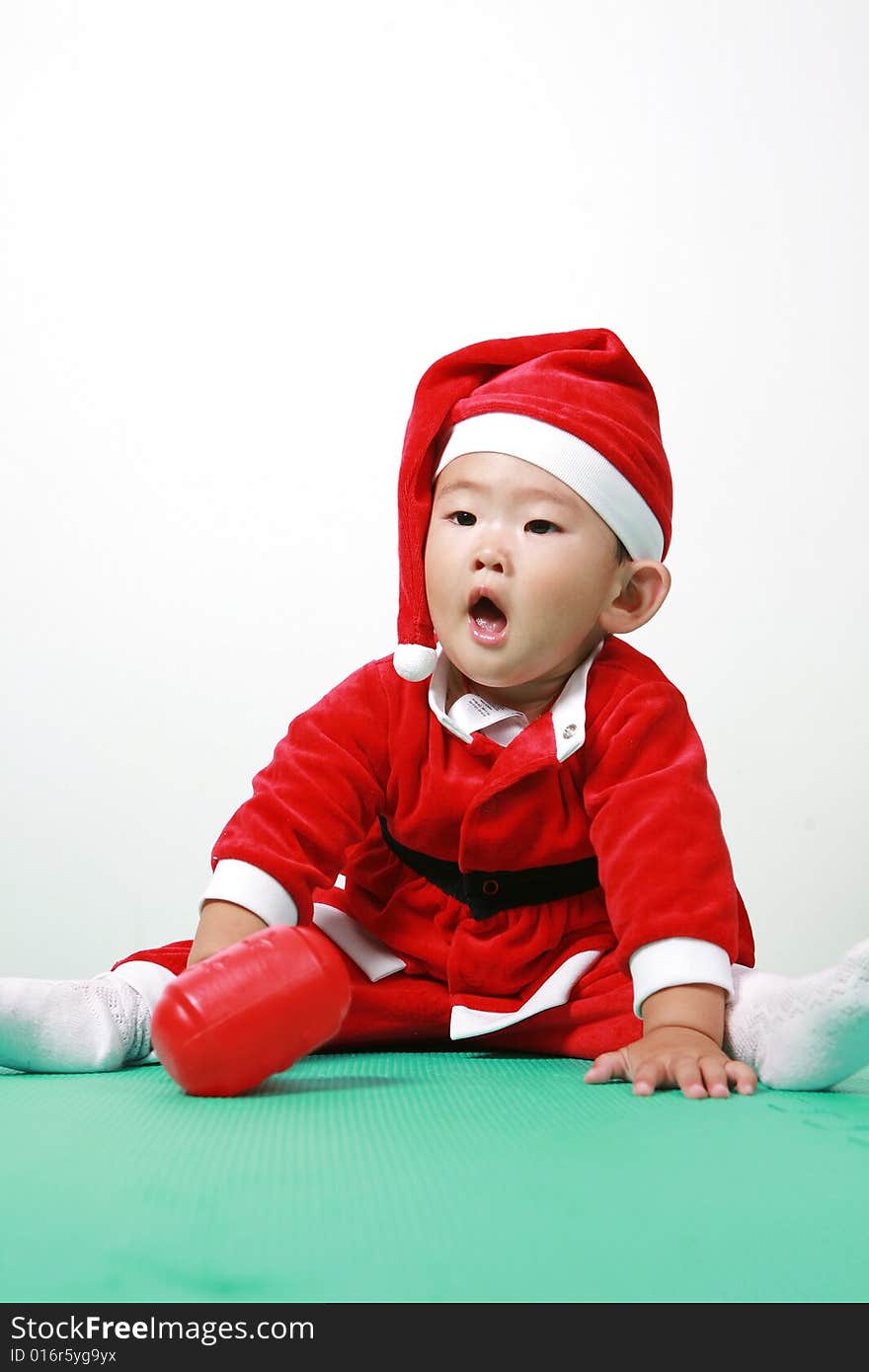 Cute chinese baby boy in a santas outfit. Cute chinese baby boy in a santas outfit