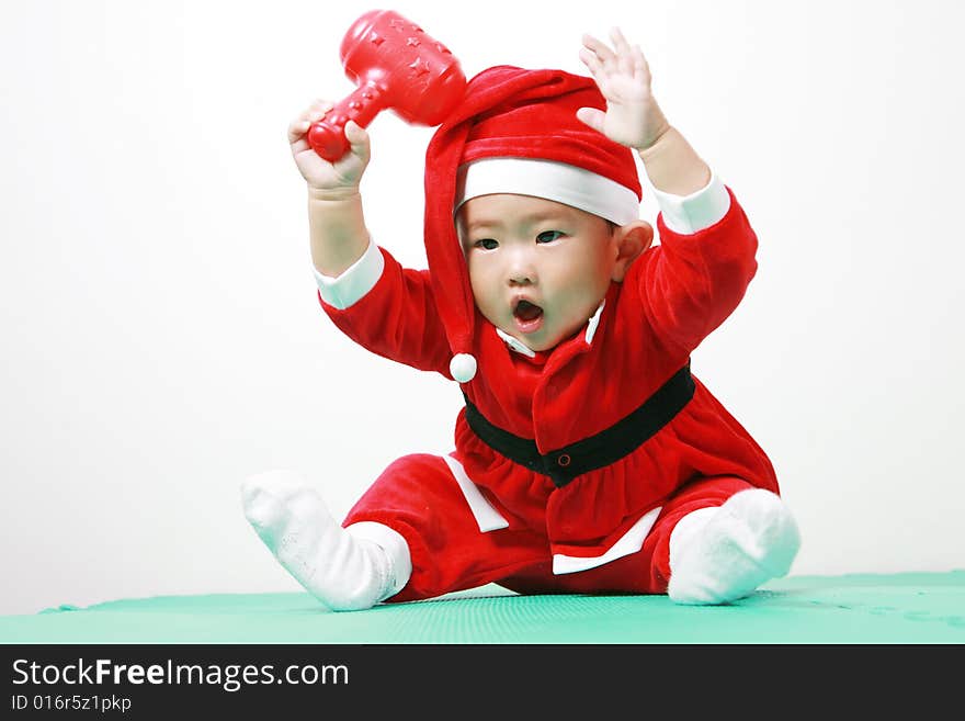 Cute chinese baby boy in a santas outfit. Cute chinese baby boy in a santas outfit