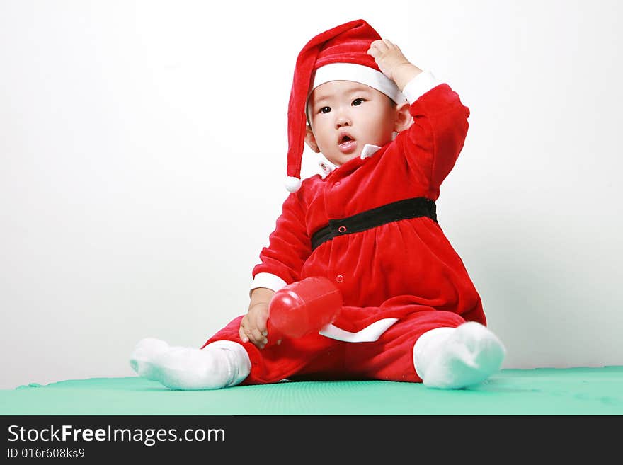 Cute chinese baby boy in a santas outfit. Cute chinese baby boy in a santas outfit