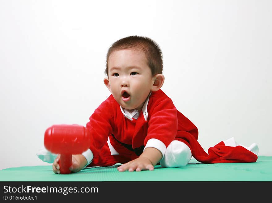 Cute chinese baby boy in a santas outfit. Cute chinese baby boy in a santas outfit