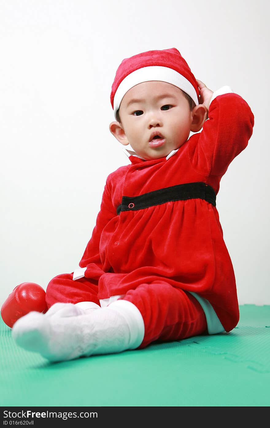 Cute chinese baby boy in a santas outfit. Cute chinese baby boy in a santas outfit