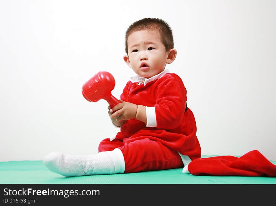 Cute chinese baby boy in a santas outfit. Cute chinese baby boy in a santas outfit