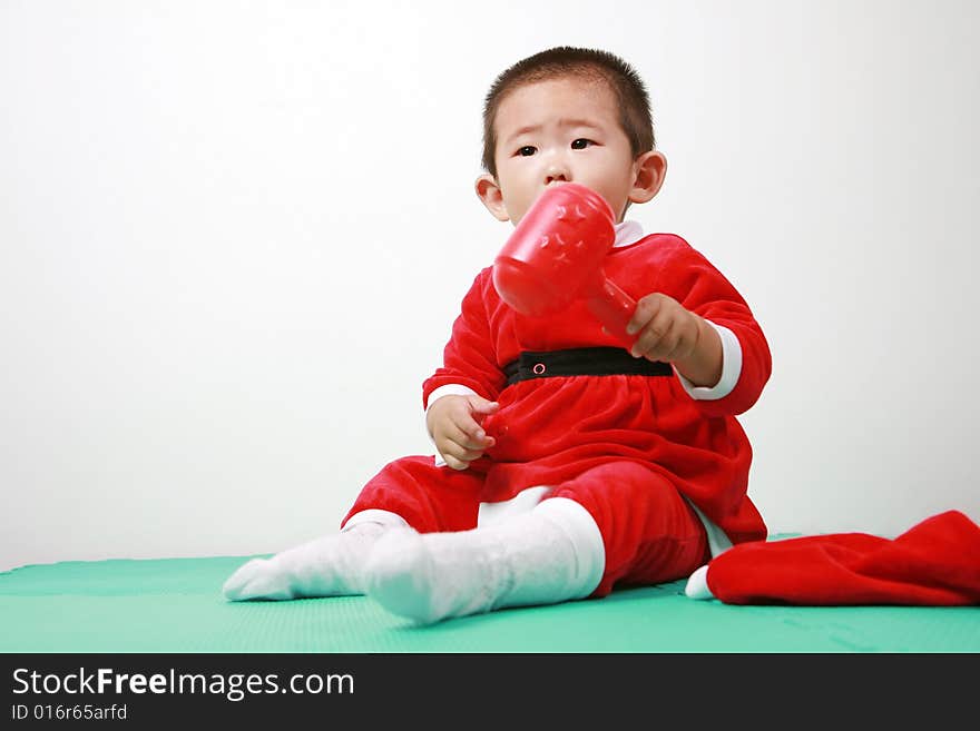 Cute chinese baby boy in a santas outfit. Cute chinese baby boy in a santas outfit