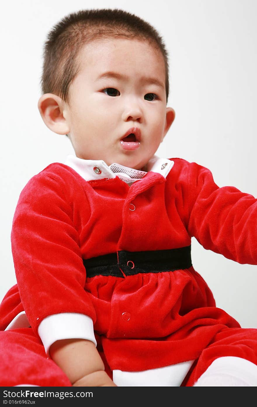 Cute chinese baby boy in a santas outfit. Cute chinese baby boy in a santas outfit