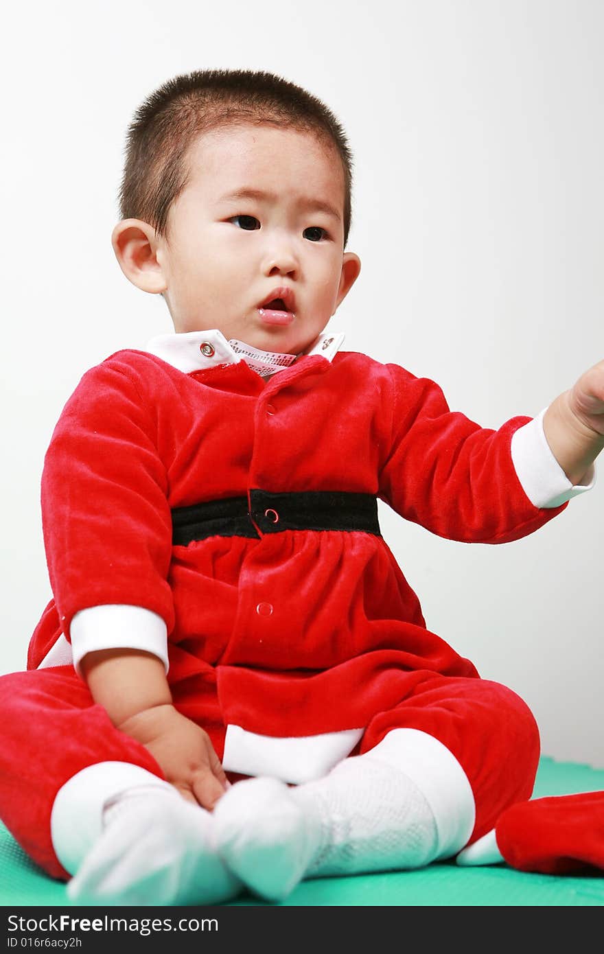 Cute chinese baby boy in a santas outfit. Cute chinese baby boy in a santas outfit