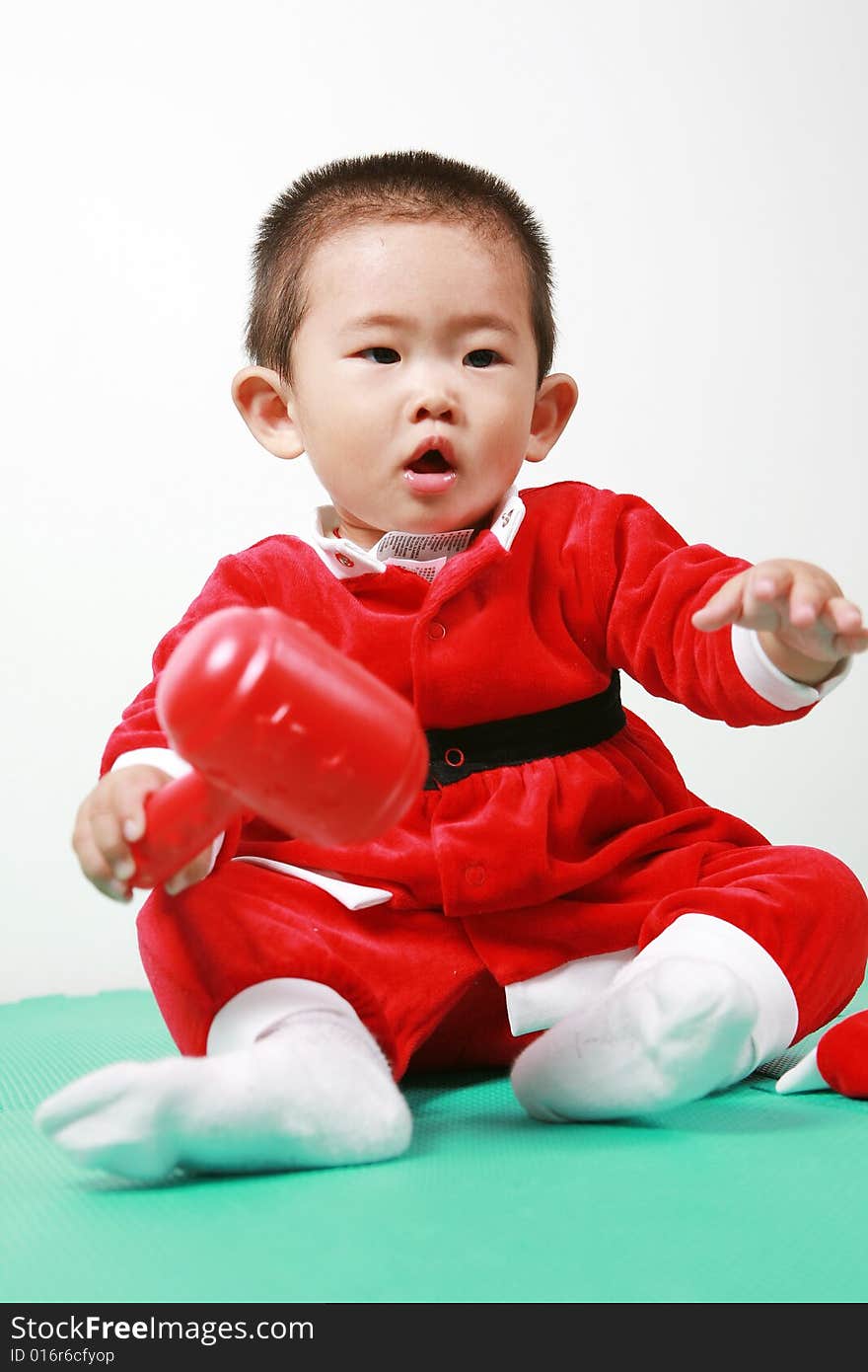 Cute chinese baby boy in a santas outfit. Cute chinese baby boy in a santas outfit