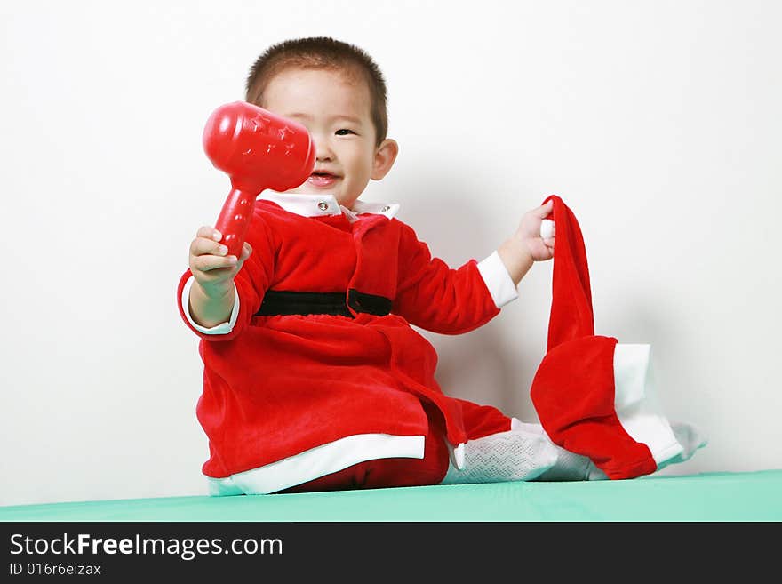 Cute chinese baby boy in a santas outfit. Cute chinese baby boy in a santas outfit