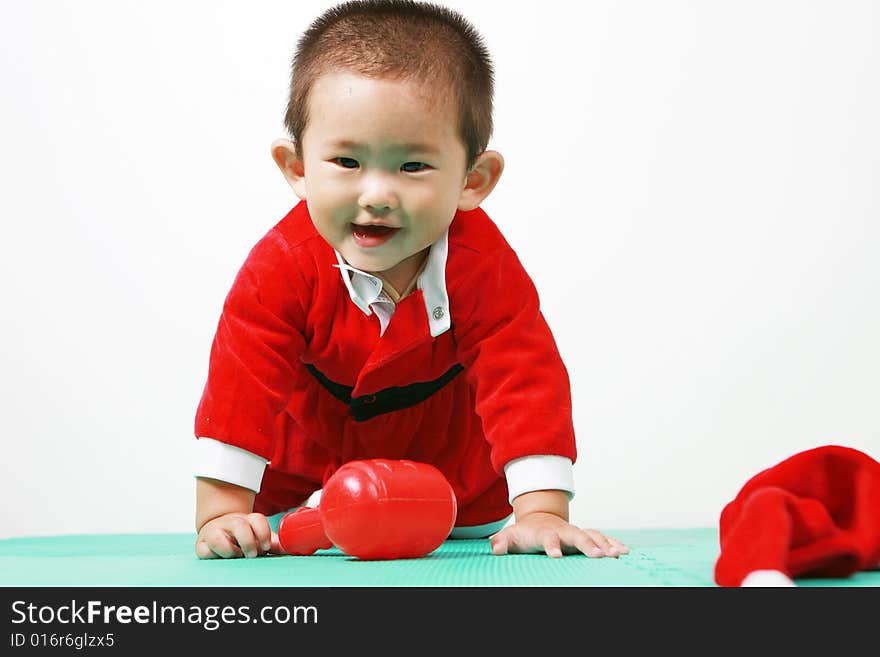 Cute chinese baby boy in a santas outfit. Cute chinese baby boy in a santas outfit