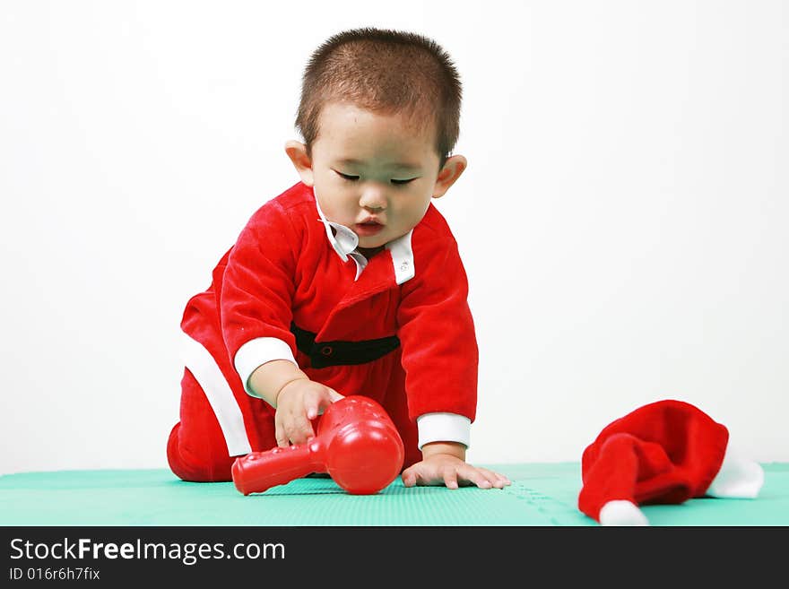 Cute chinese baby boy in a santas outfit. Cute chinese baby boy in a santas outfit