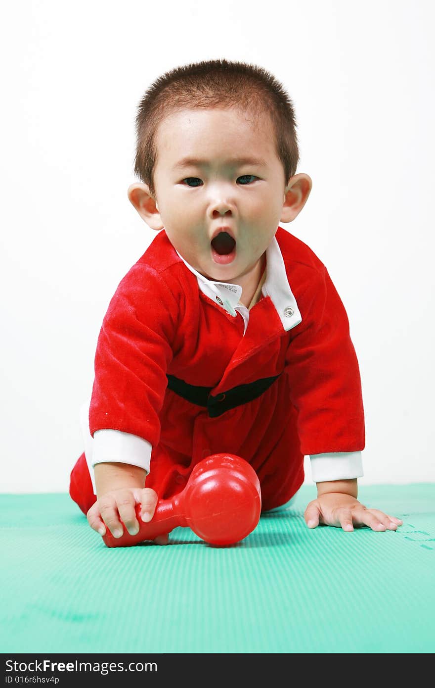 Cute chinese baby boy in a santas outfit. Cute chinese baby boy in a santas outfit