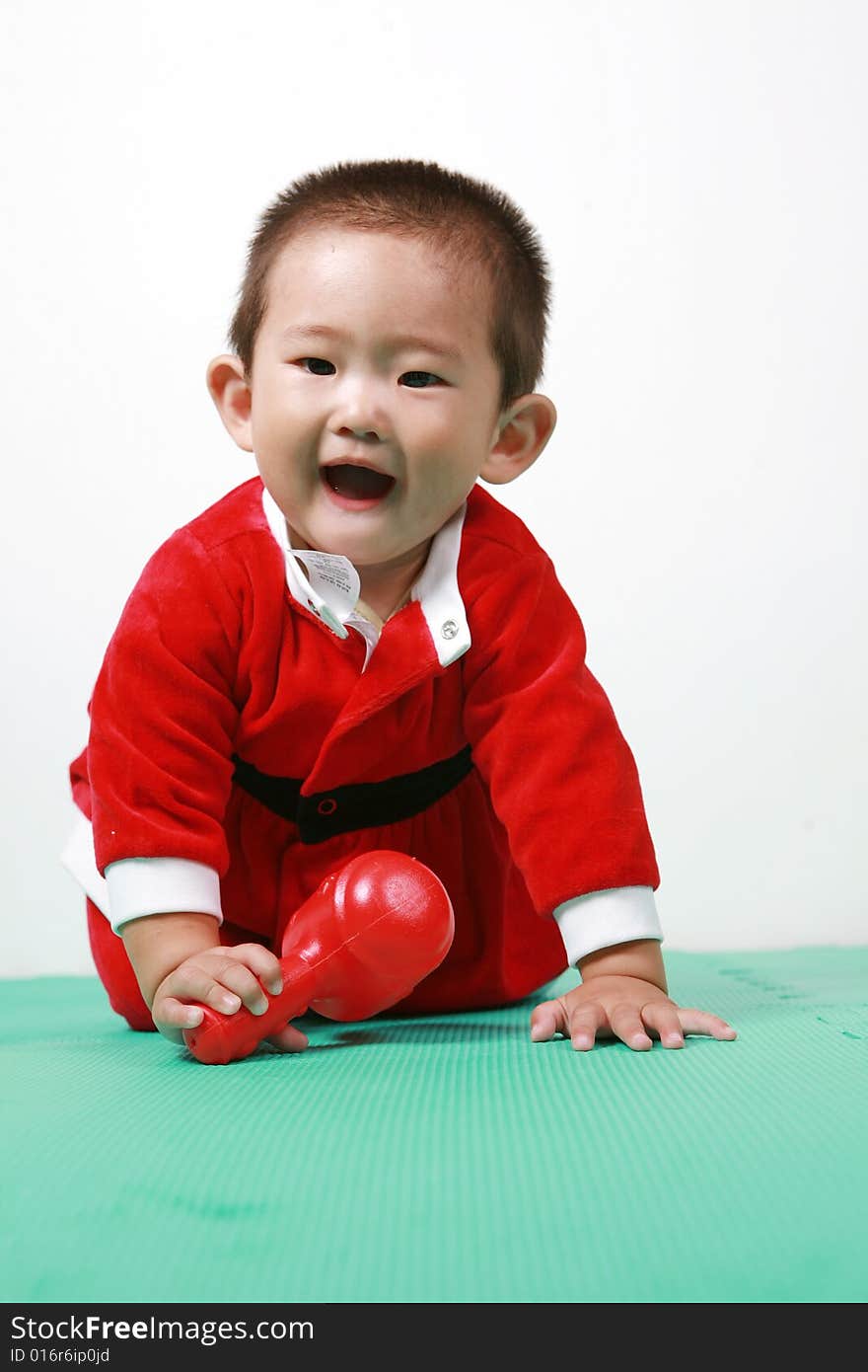 Cute chinese baby boy in a santas outfit. Cute chinese baby boy in a santas outfit