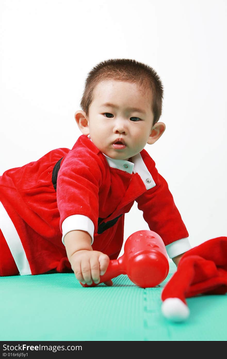 Cute chinese baby boy in a santas outfit. Cute chinese baby boy in a santas outfit