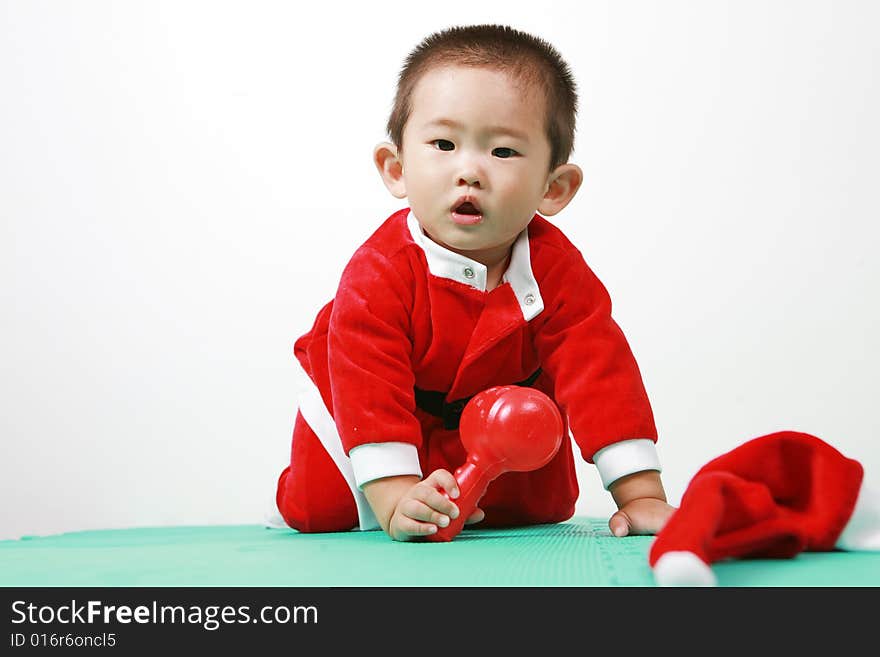 Cute chinese baby boy in a santas outfit. Cute chinese baby boy in a santas outfit