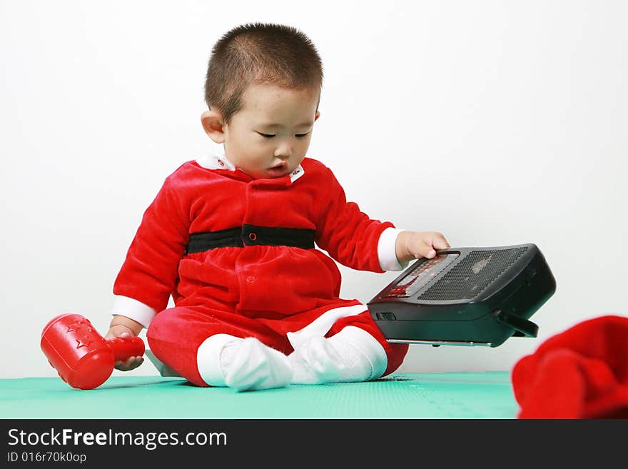 Cute chinese baby boy in a santas outfit. Cute chinese baby boy in a santas outfit