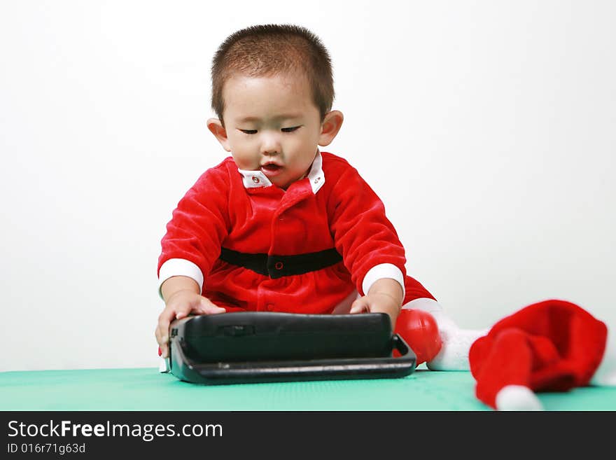 Cute chinese baby boy in a santas outfit. Cute chinese baby boy in a santas outfit