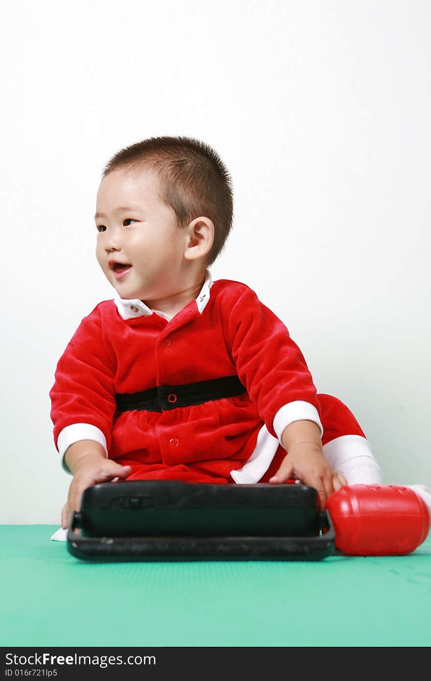 Cute chinese baby boy in a santas outfit. Cute chinese baby boy in a santas outfit