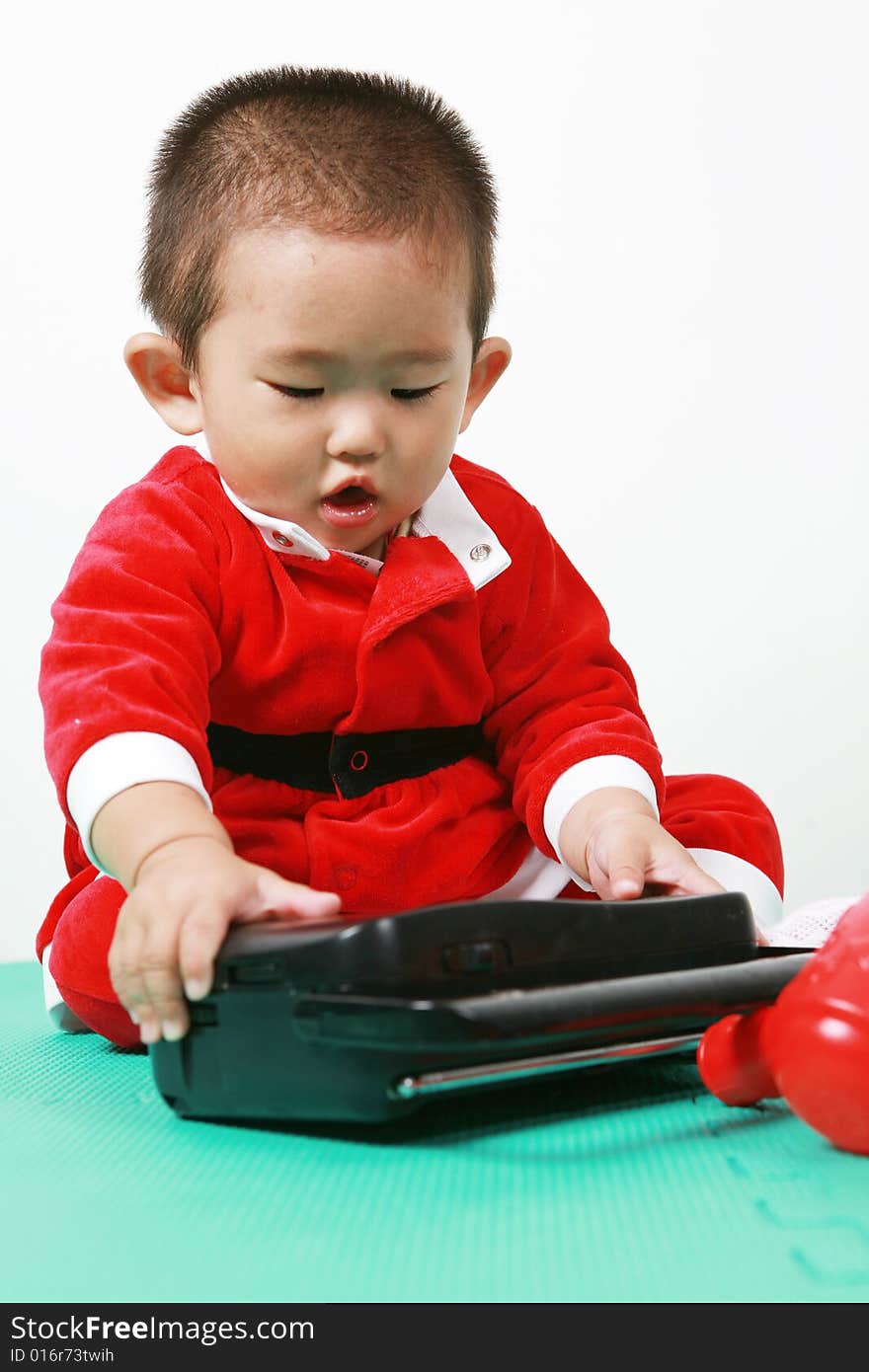 Cute chinese baby boy in a santas outfit. Cute chinese baby boy in a santas outfit