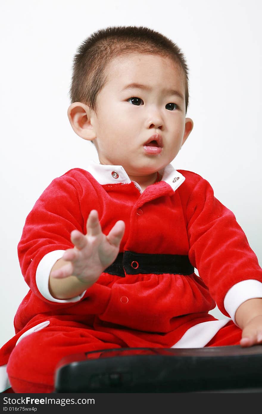 Cute chinese baby boy in a santas outfit. Cute chinese baby boy in a santas outfit