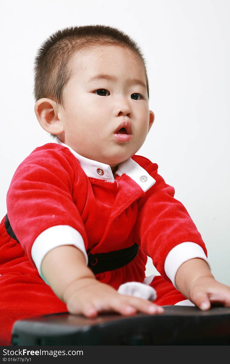 Cute chinese baby boy in a santas outfit. Cute chinese baby boy in a santas outfit