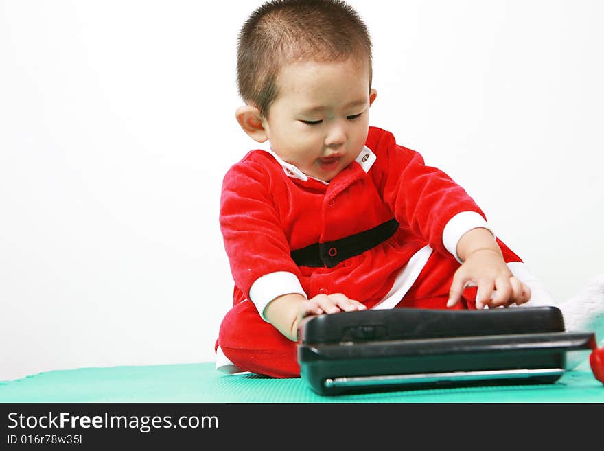 Cute chinese baby boy in a santas outfit. Cute chinese baby boy in a santas outfit