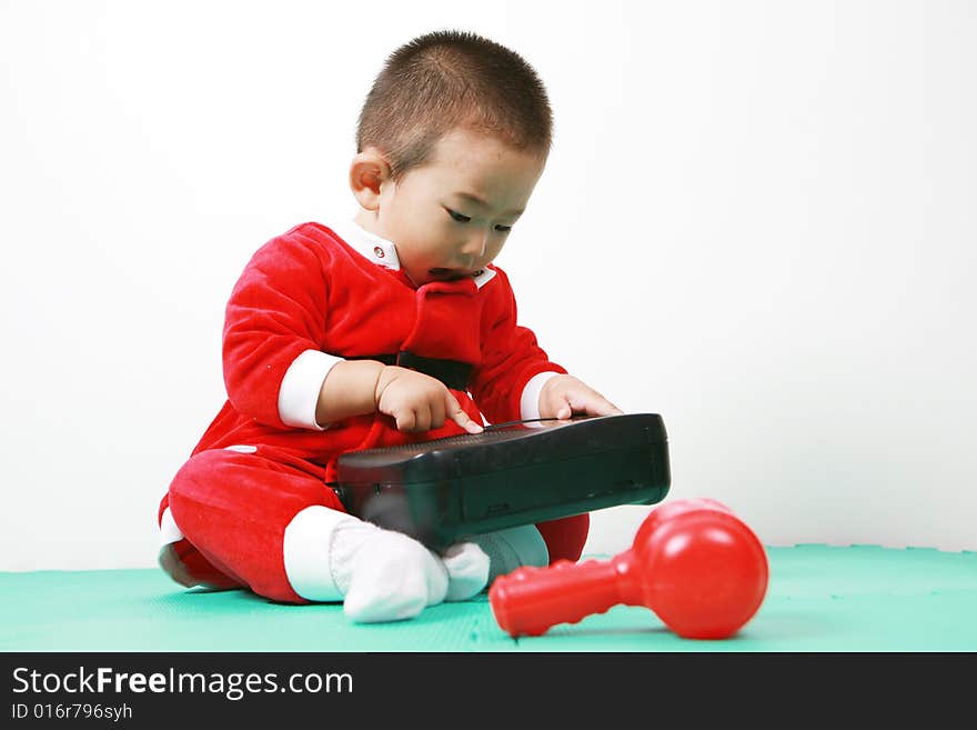 Cute chinese baby boy in a santas outfit. Cute chinese baby boy in a santas outfit