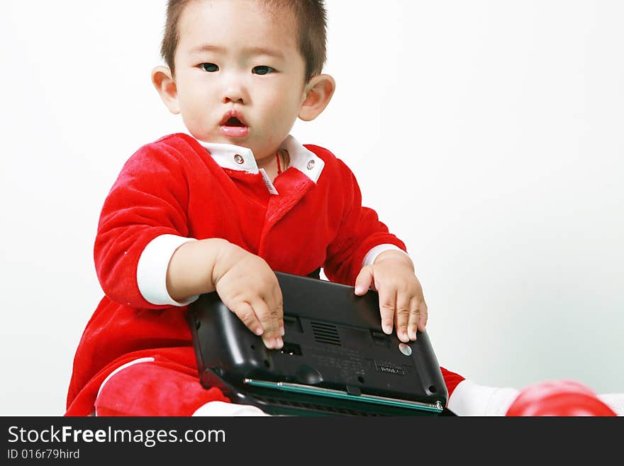 Cute chinese baby boy in a santas outfit. Cute chinese baby boy in a santas outfit