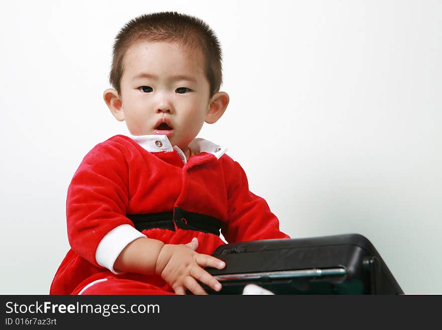 Cute chinese baby boy in a santas outfit. Cute chinese baby boy in a santas outfit