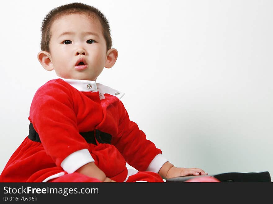 Cute chinese baby boy in a santas outfit. Cute chinese baby boy in a santas outfit