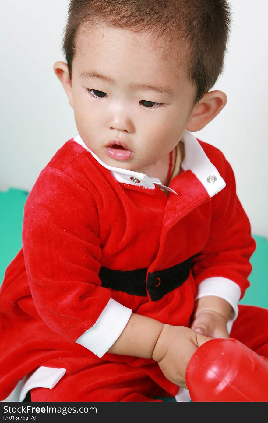 Cute chinese baby boy in a santas outfit. Cute chinese baby boy in a santas outfit