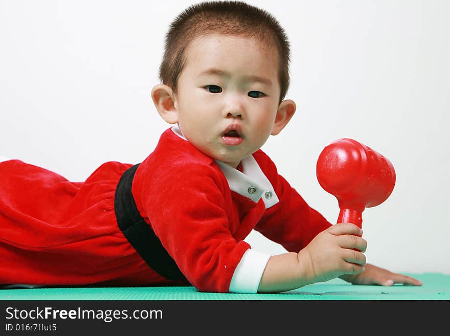 Cute chinese baby boy in a santas outfit. Cute chinese baby boy in a santas outfit