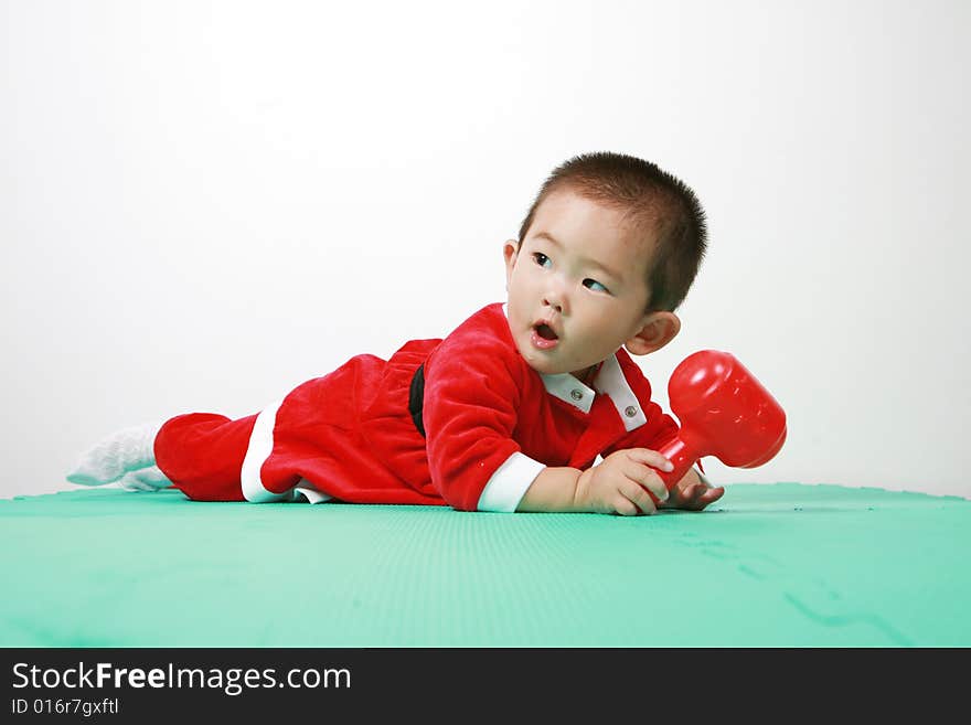 Cute chinese baby boy in a santas outfit. Cute chinese baby boy in a santas outfit