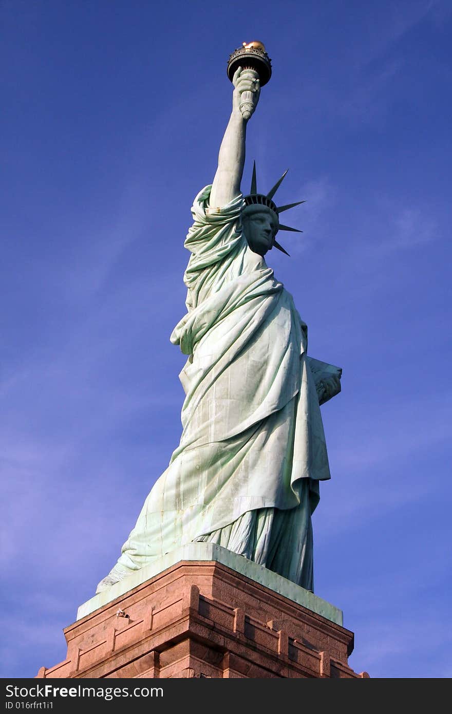 The Statue of Liberty in the harbour of Manhattan on a crisp winters morning with blue sky.