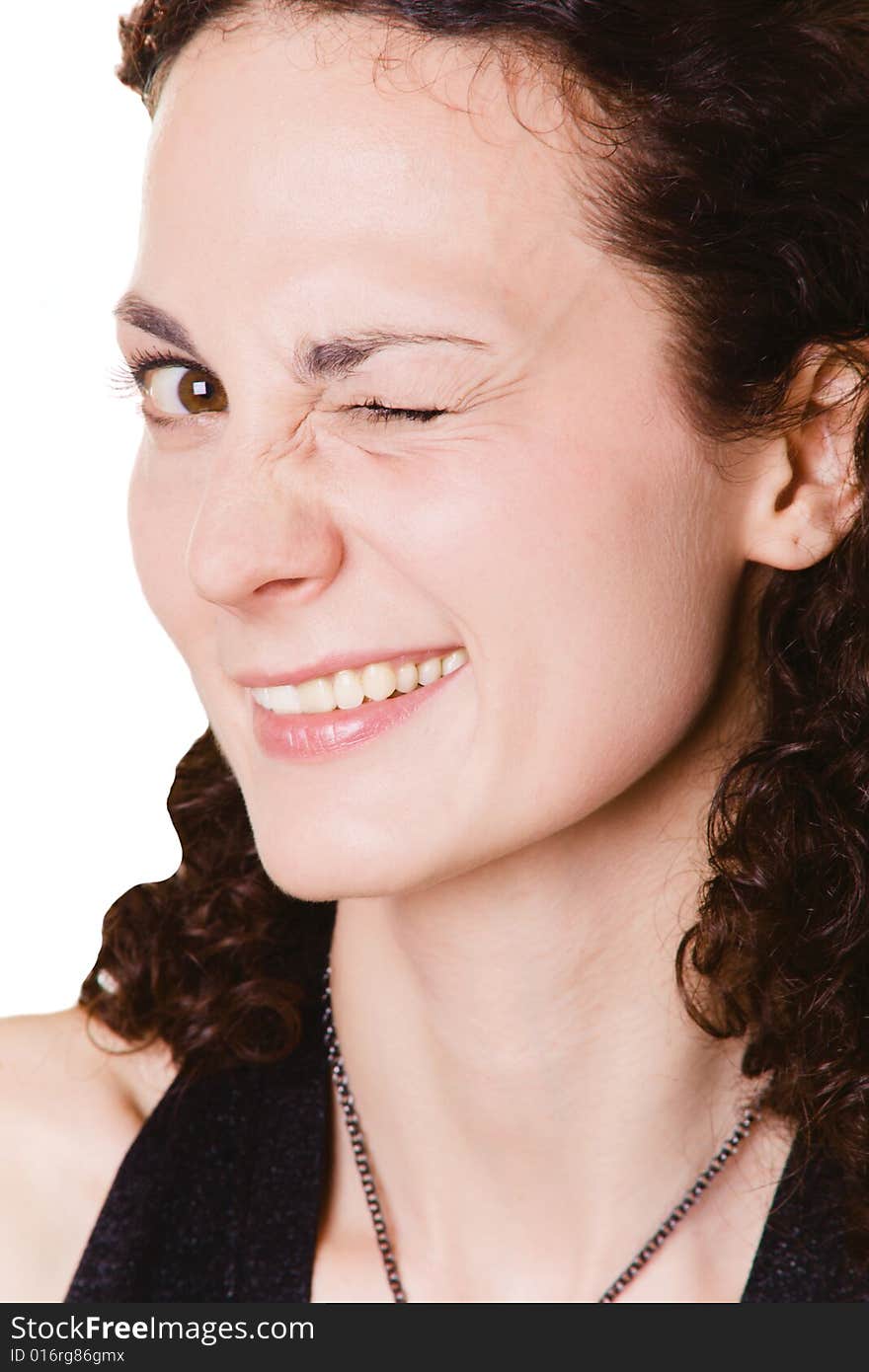 Young woman winking with one eye on white background