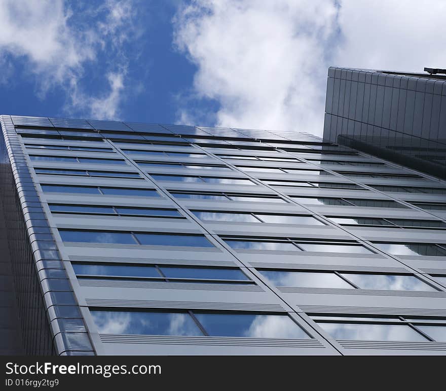 Modern office glass building with blue sky. Modern office glass building with blue sky