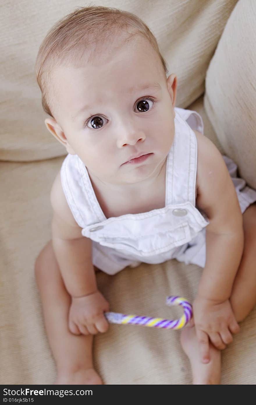 Beautiful baby boy looking with curiosity directly to the camera