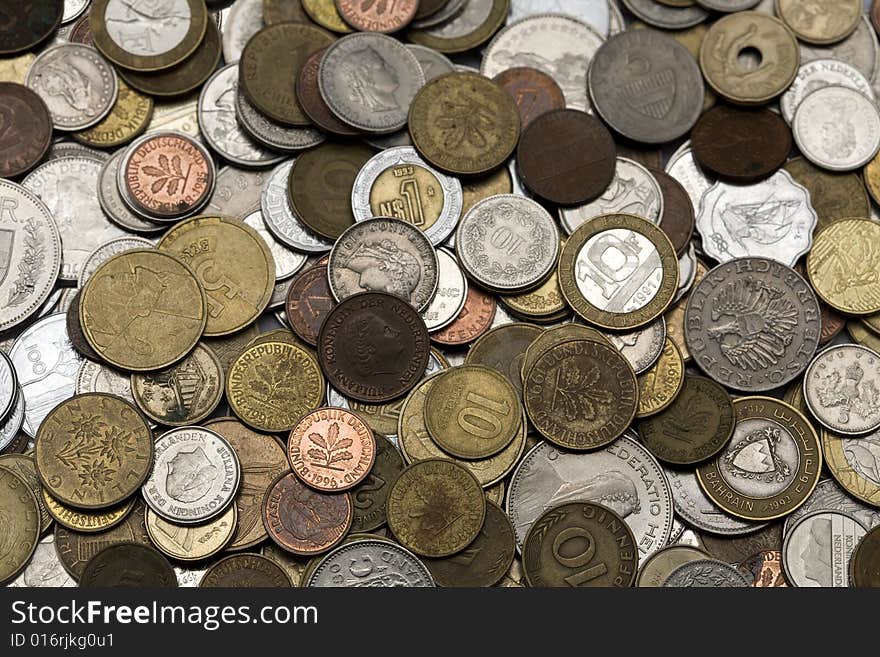 Loads of coins from around the world, isolated. Loads of coins from around the world, isolated.