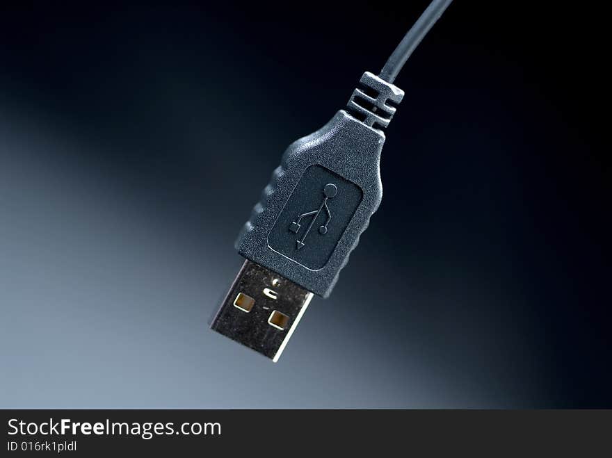 Black USB comouter cable with a dark shaded background. Black USB comouter cable with a dark shaded background