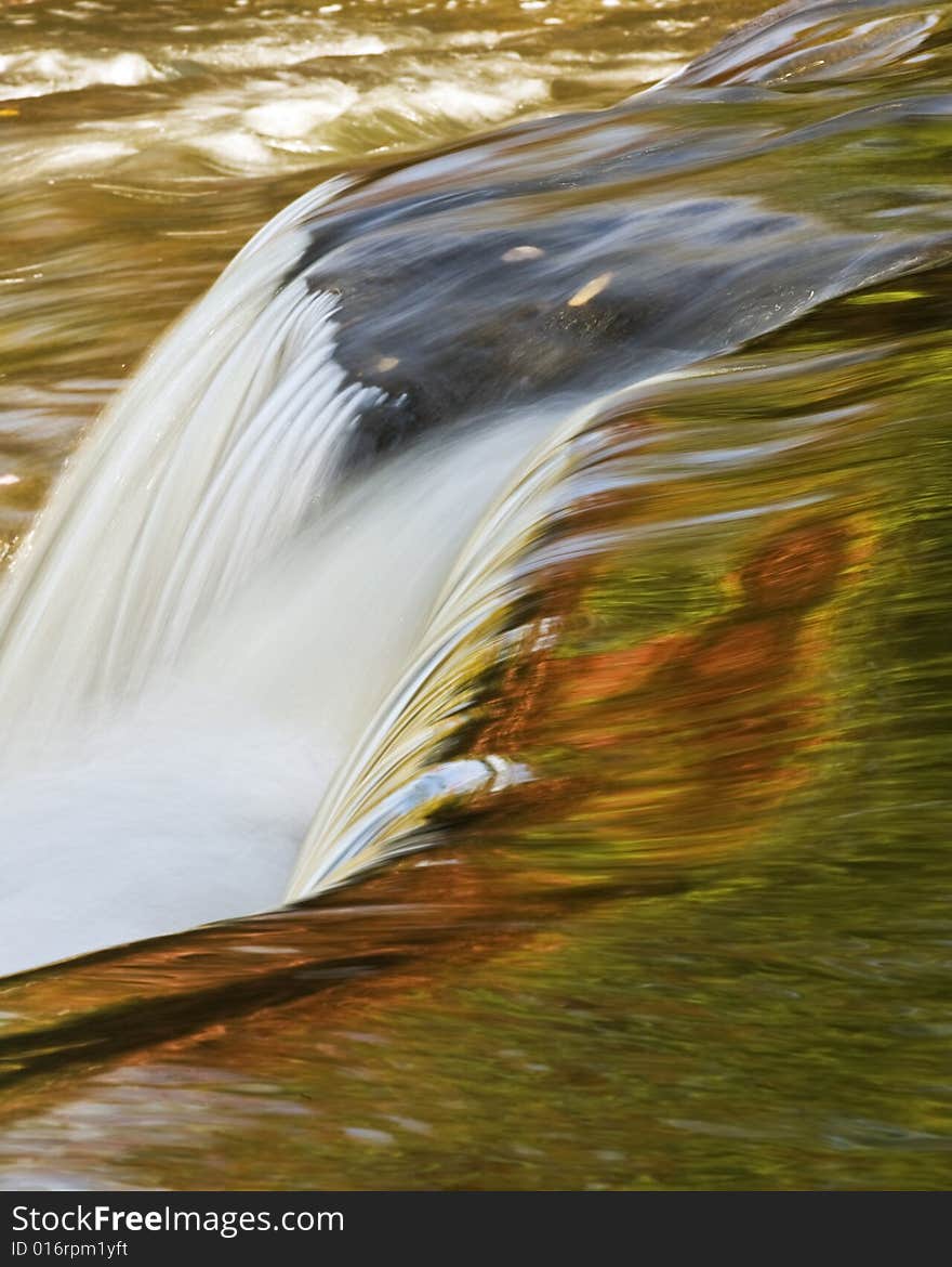 Bond Falls in Upper Peninsula of Michigan from the top showing colors reflecting from the fall foliage. Bond Falls in Upper Peninsula of Michigan from the top showing colors reflecting from the fall foliage.